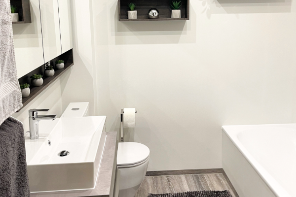 Bright bathroom with grey wood-effect vinyl flooring