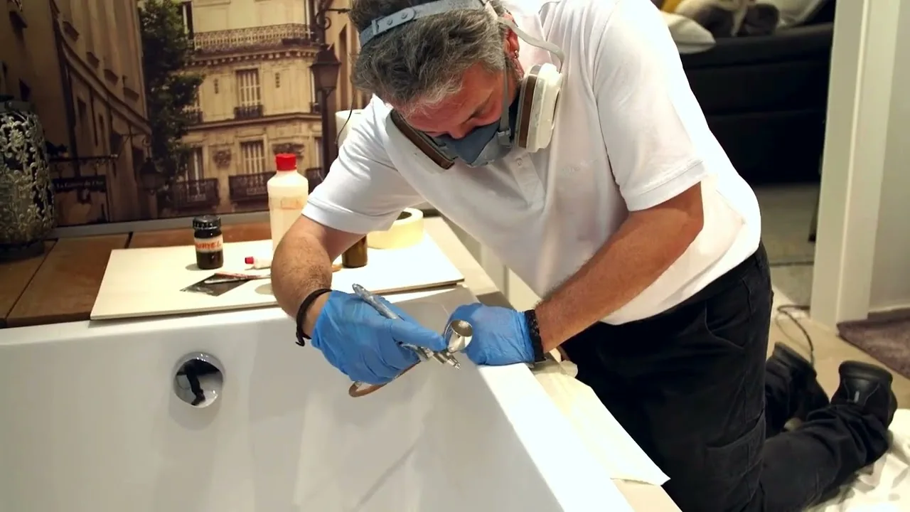 bazuba Technician repairing a bathtub with a spray gun